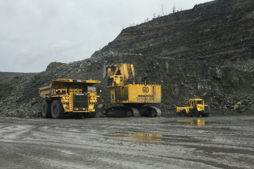 Heavy mining truck on a haul road near a rocky mountain, representing the range of equipment feeding crushers and mills