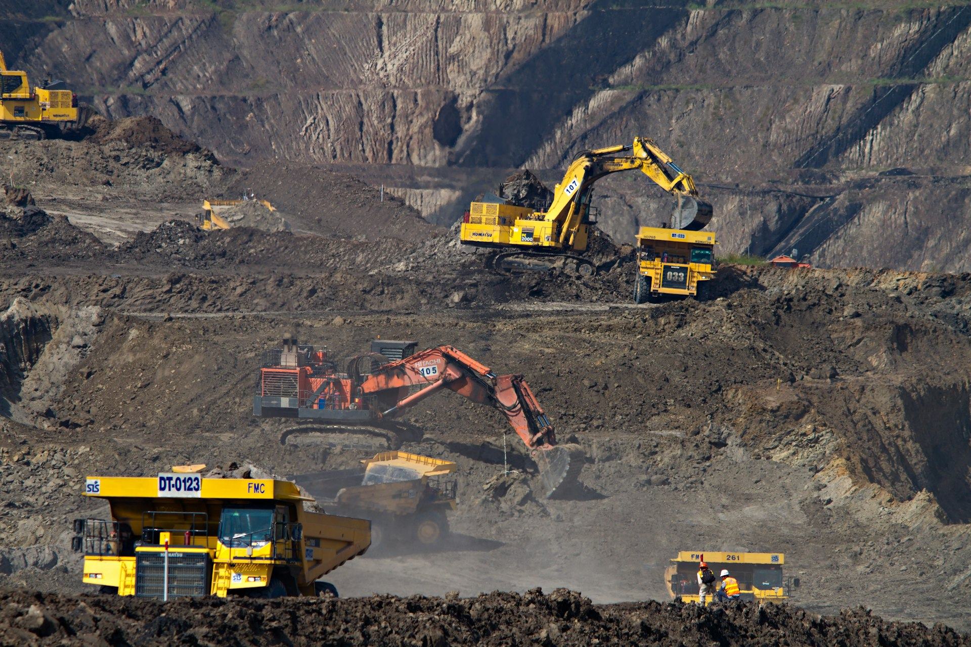 Open-pit mining operations with excavators and haul trucks